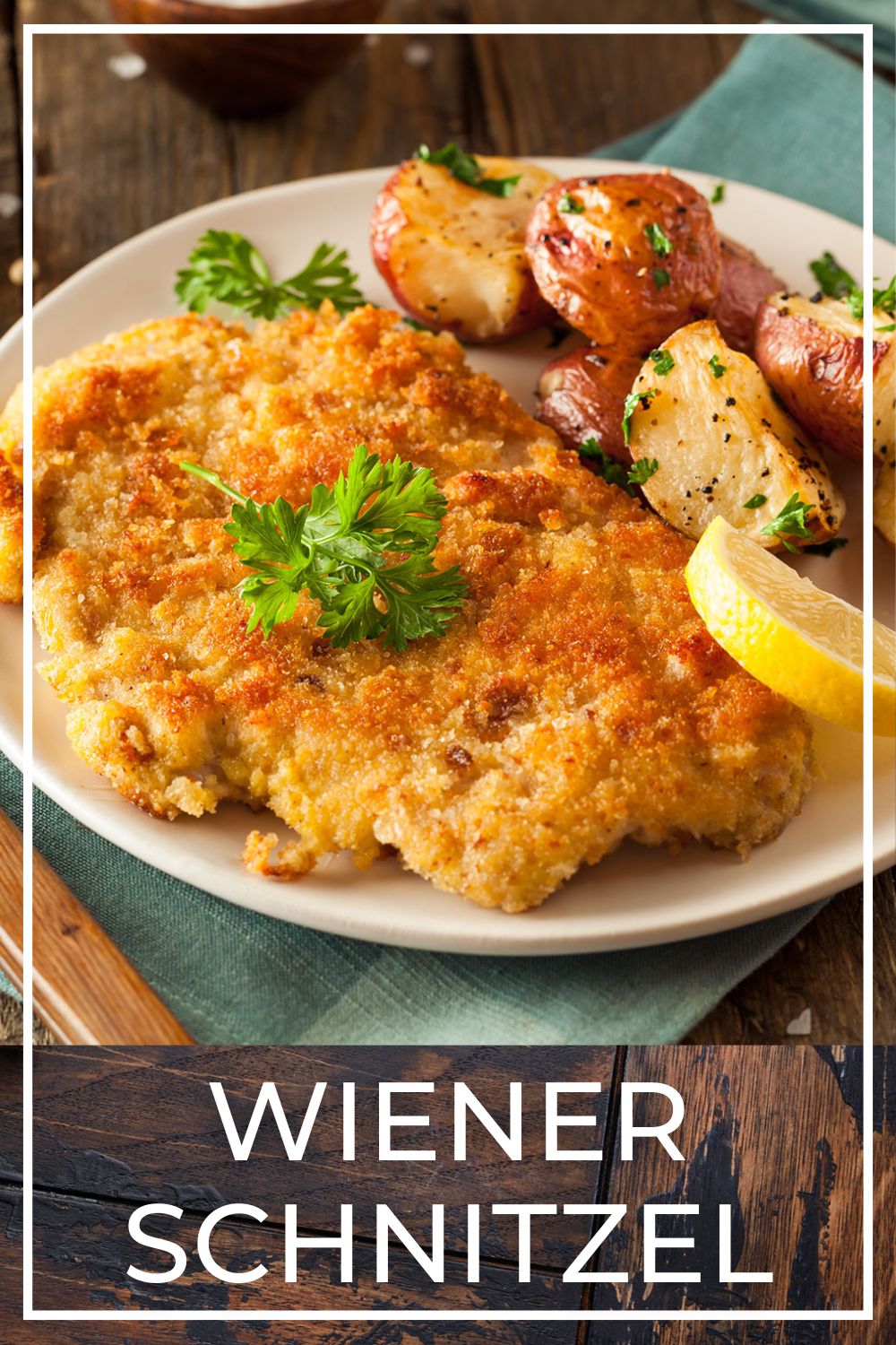 Crispy golden-brown Wiener schnitzel served with lemon wedges and parsley garnish on a white plate.