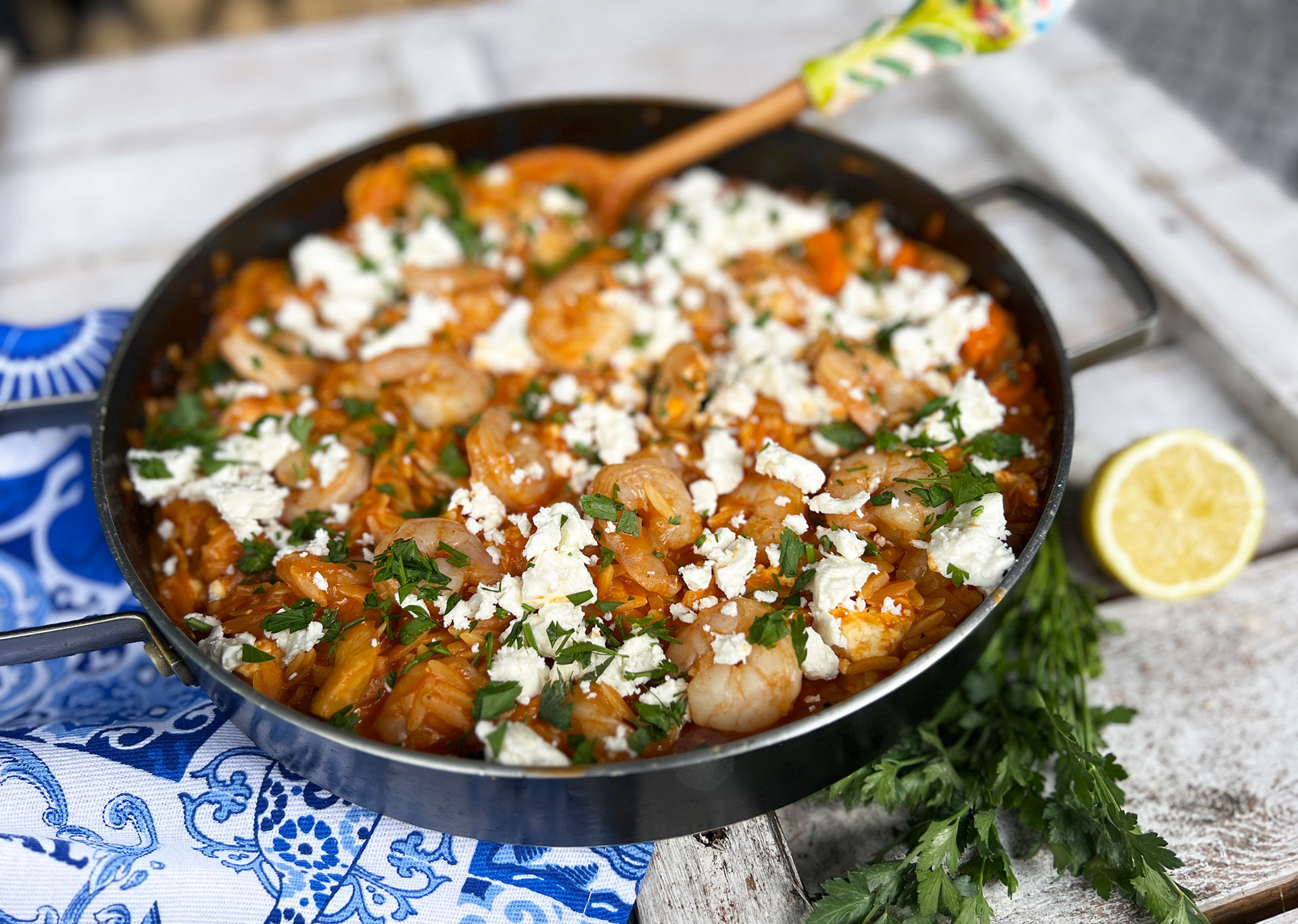 Yiouvetsi met gamba’s, venkel en orzo in een ovenschaal met feta en peterselie