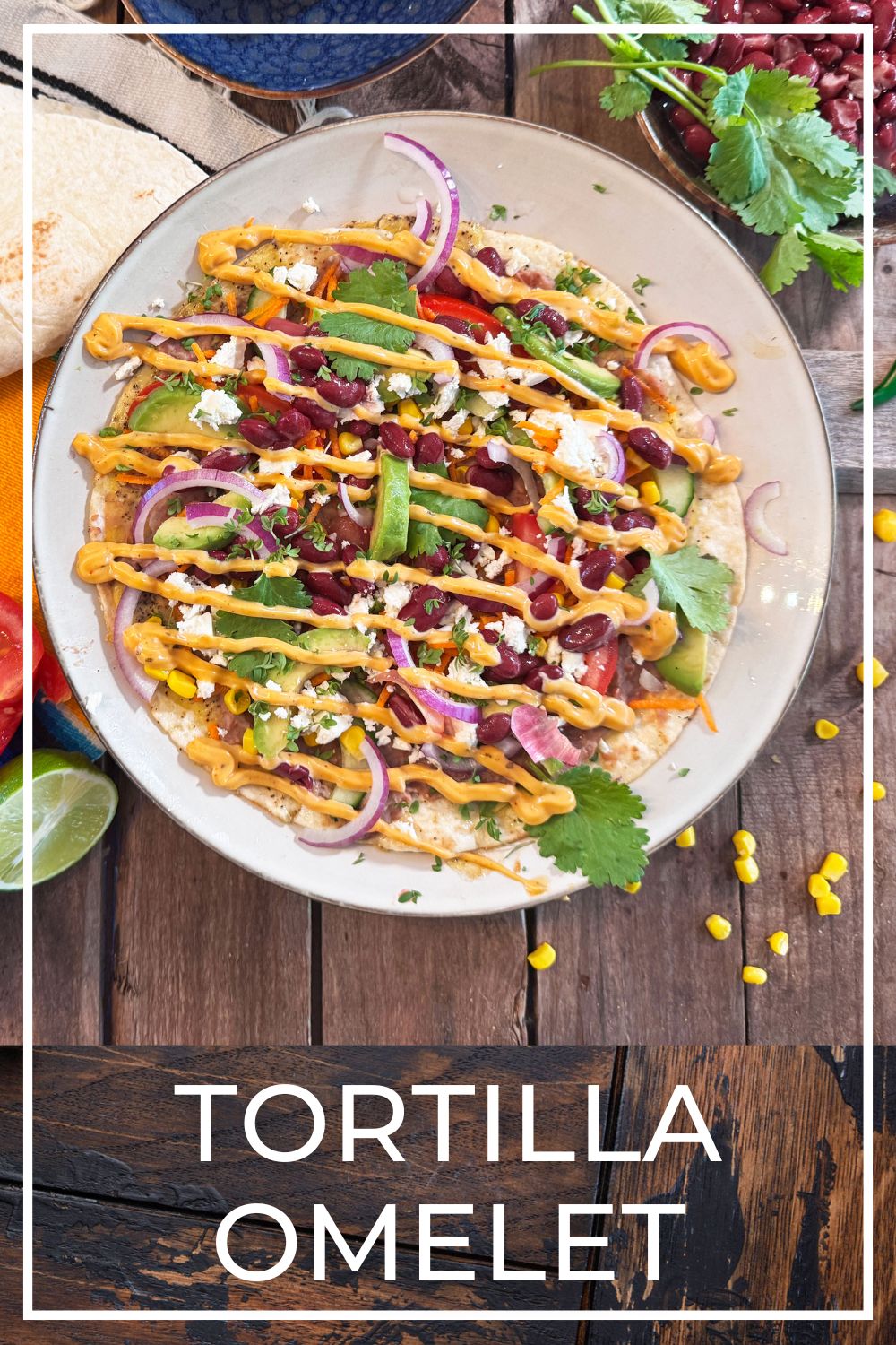 Mexican tortilla omelet topped with beans, avocado, tomato and fresh vegetables