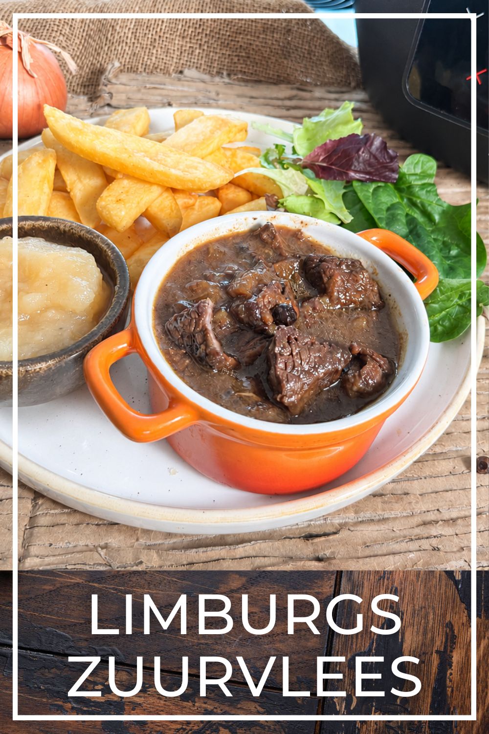 Traditional Limburg sour beef stew with fries and applesauce