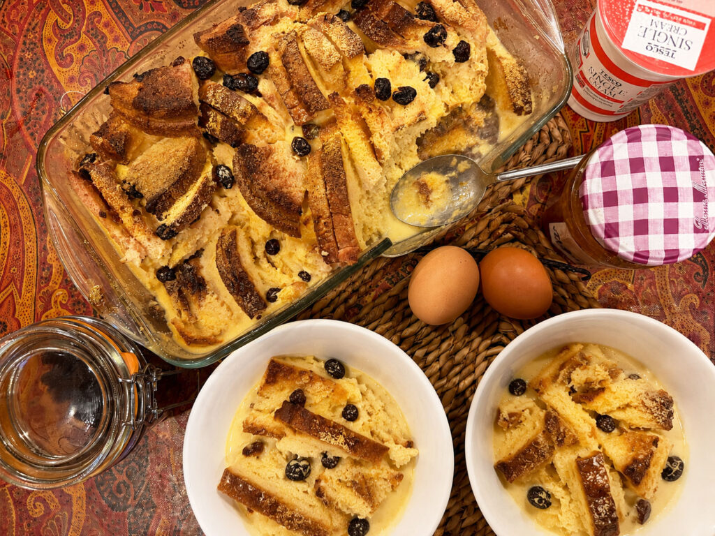Traditional British Bread and Butter Pudding with creamy custard and raisins baked until golden brown.